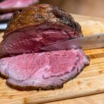 Knife cutting a slice of roast