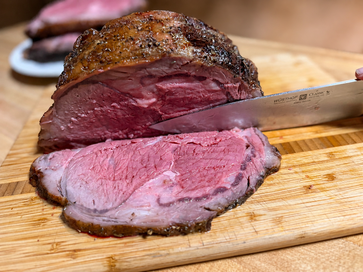 Knife cutting a slice of roast